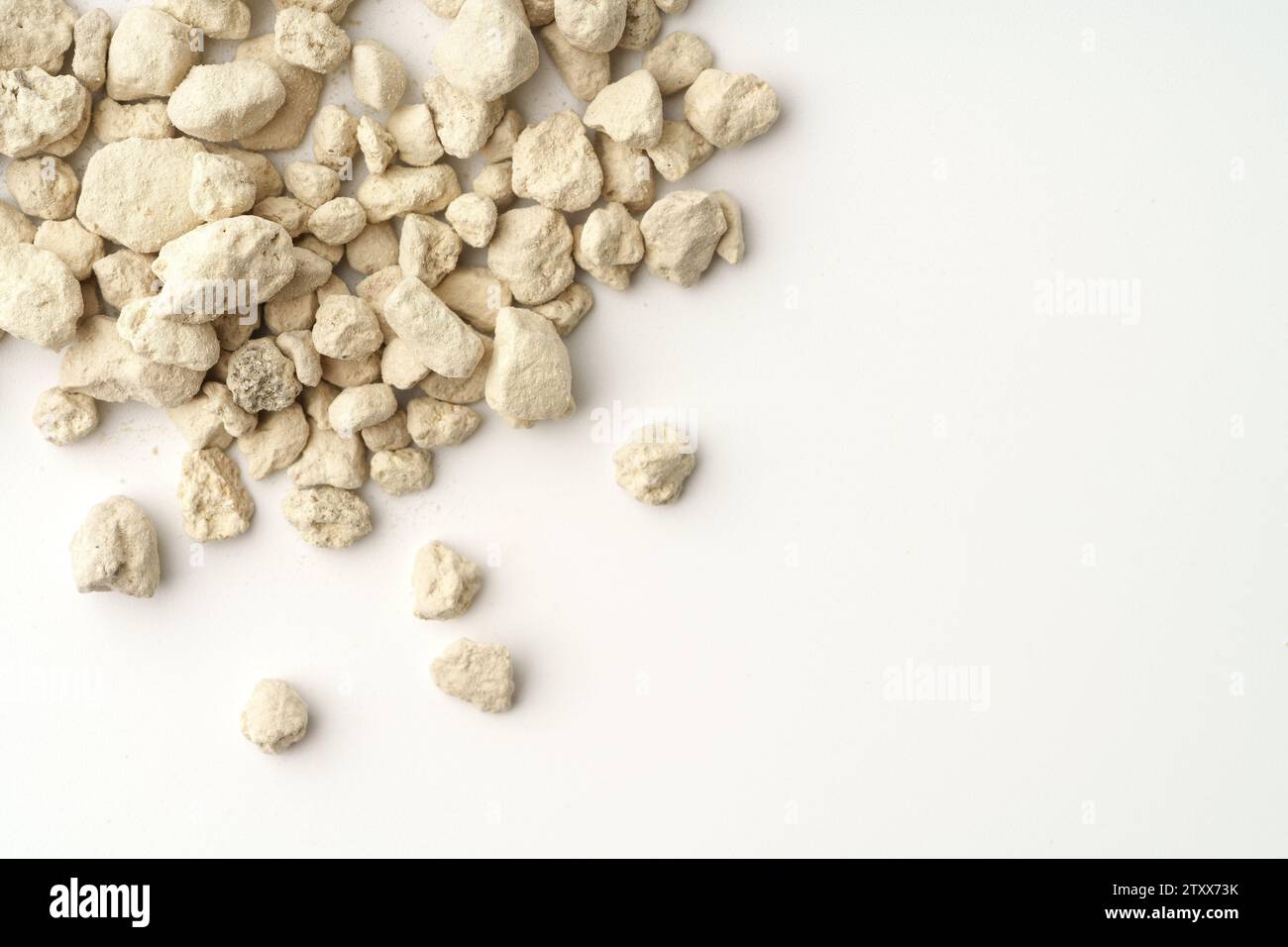 Mineral cat litter filler on white background Stock Photo Alamy