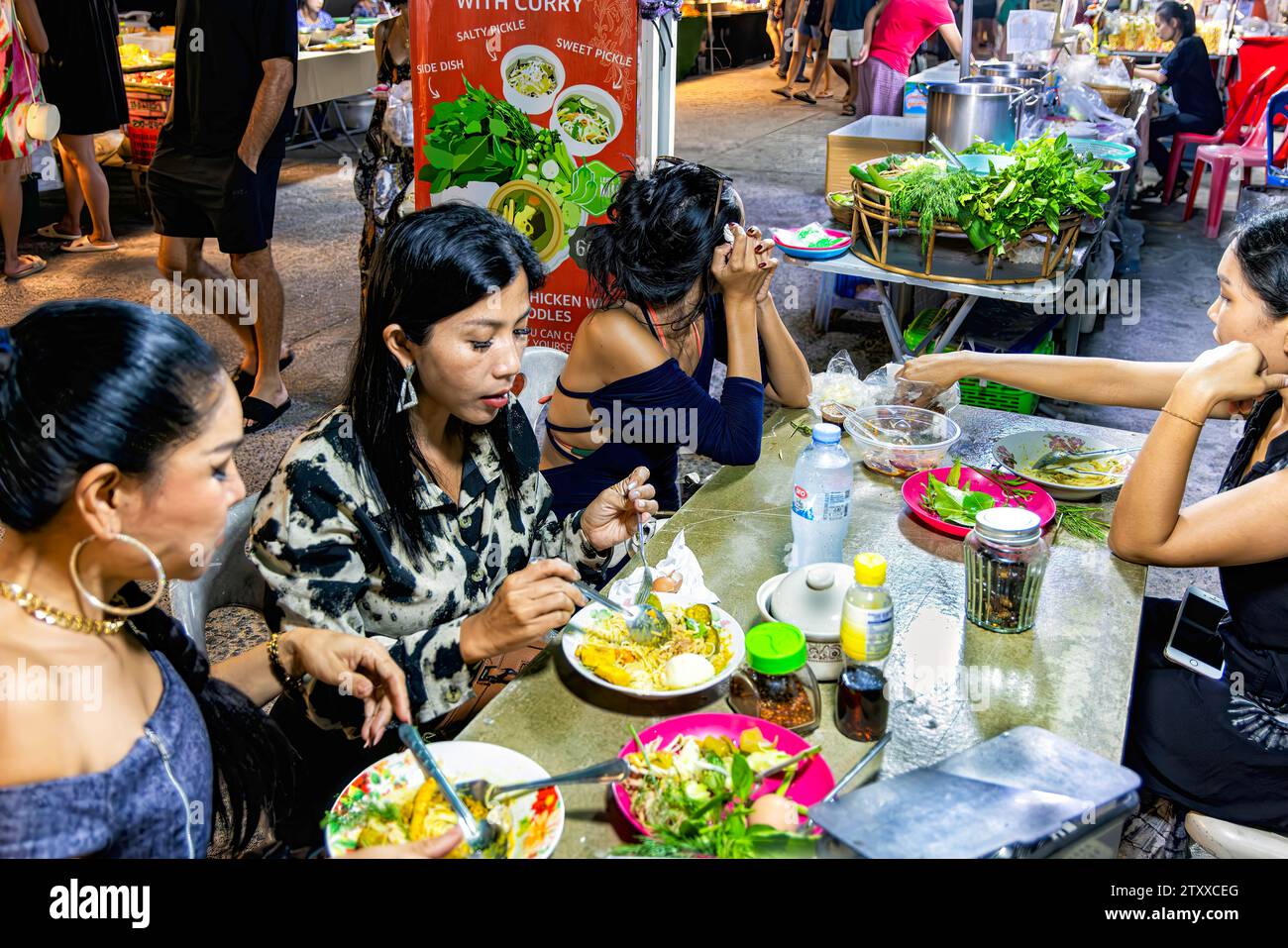 Thai girls eating at night market, Fishermans Village, Bo Phut, Ko Samui, Thailand Stock Photo