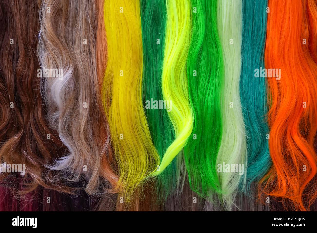 Hair samples of different colors palette. Different hair bright rich tint colors - yellow, green, crimson, orange. Various hair colors set background Stock Photo