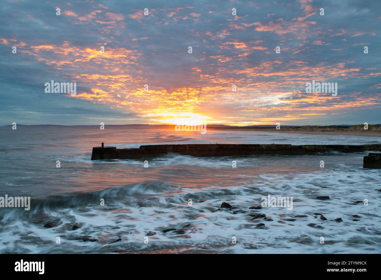 Winter sunrise over the windy sea at East Beach. Lossiemouth, Morayshire, Scotland. Stock Photo