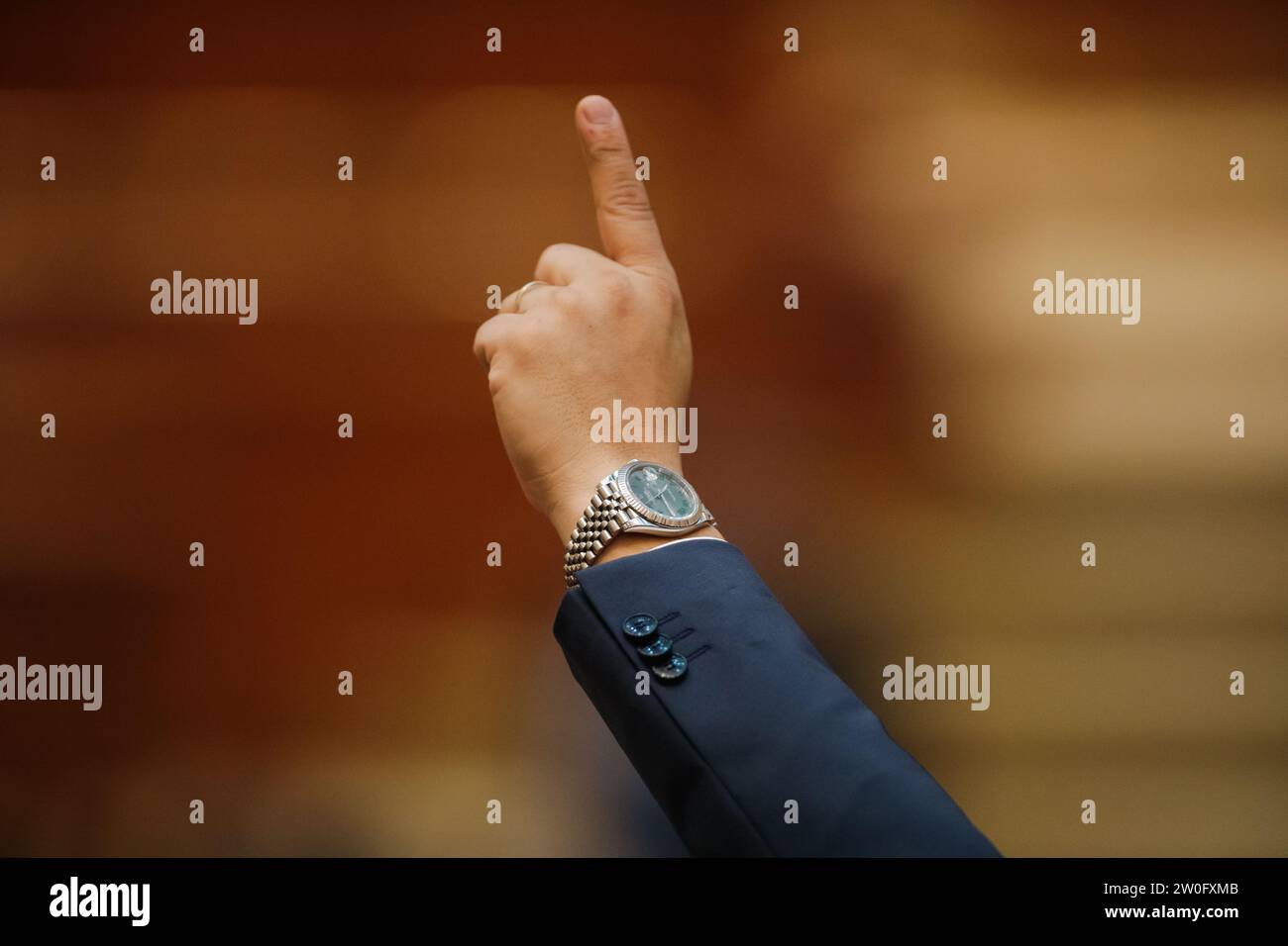 Bucharest, Romania - December 20, 2023: Member of parliament gestures to his colleagues how to vote on bills. Stock Photo