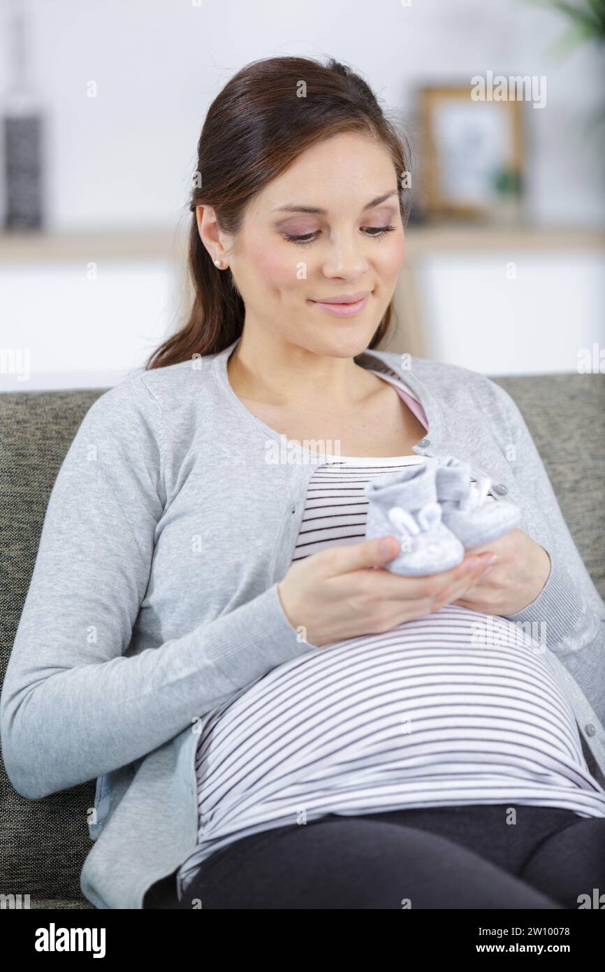 pregnant woman holding little shoes baby Stock Photo