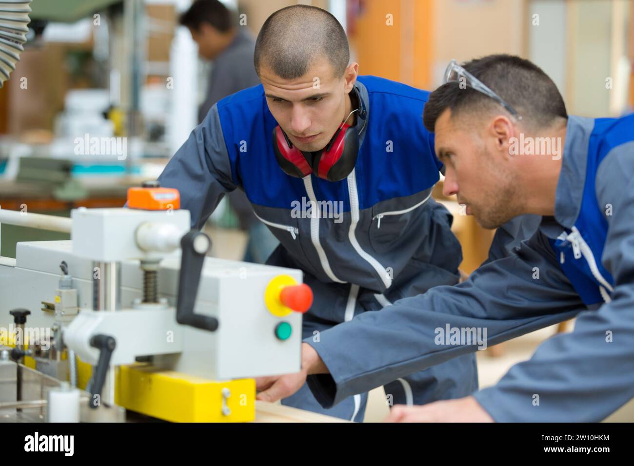two concentrated workers in factory Stock Photo
