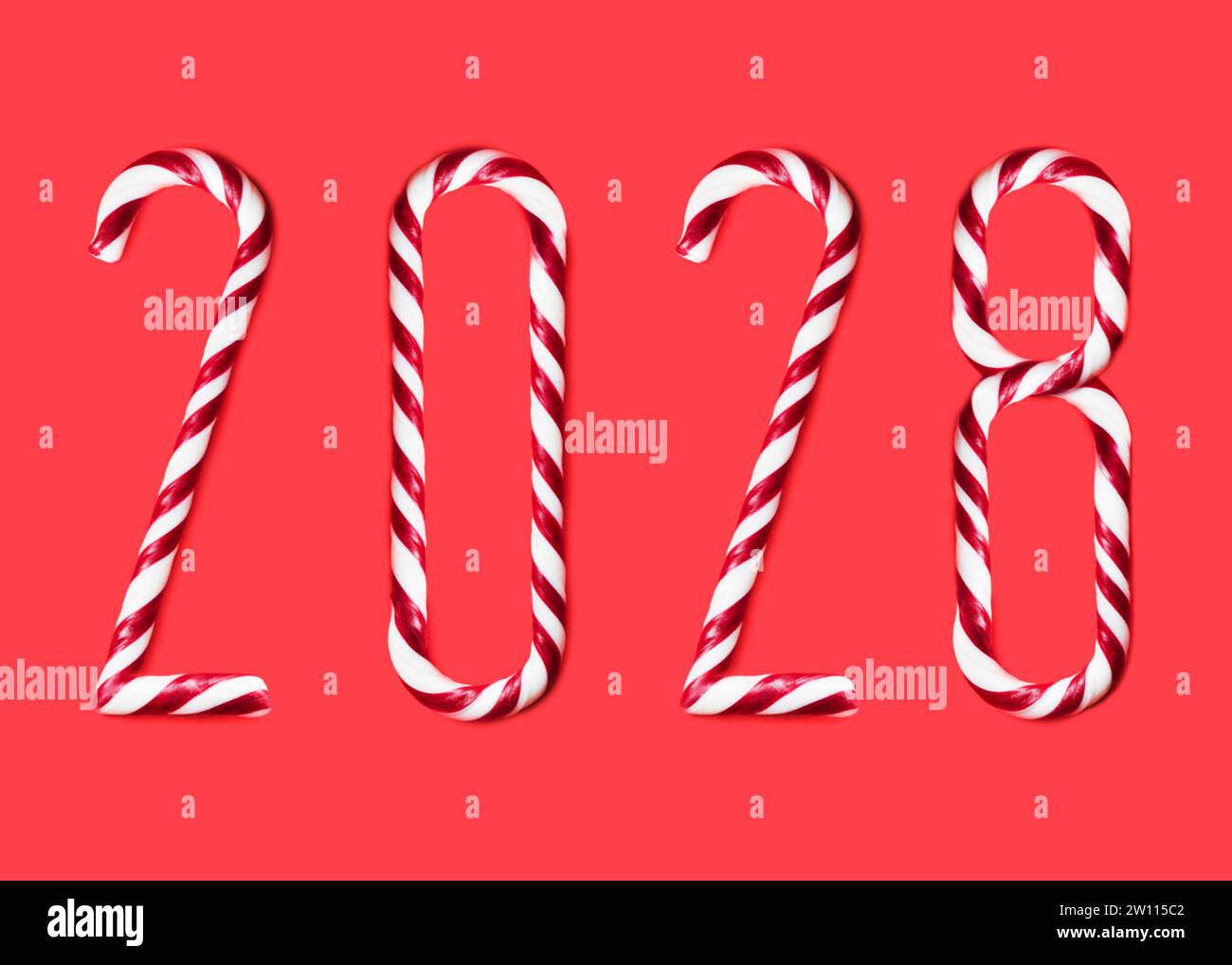 2028  made from sweet caramel canes, candies on red background Stock Photo