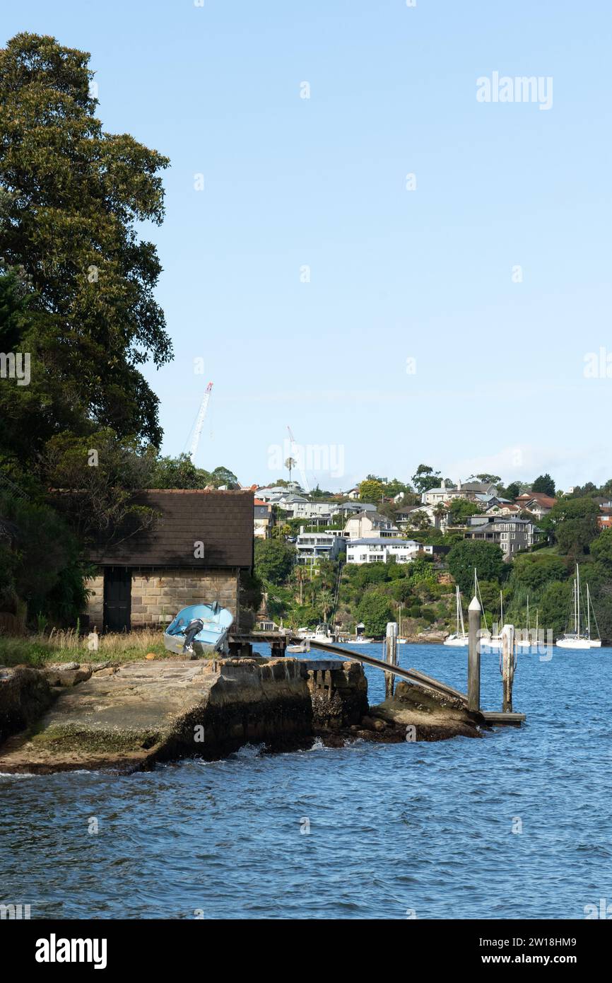 Small blue dinghy at dock on headland in Sydney Harbour Stock Photo - Alamy