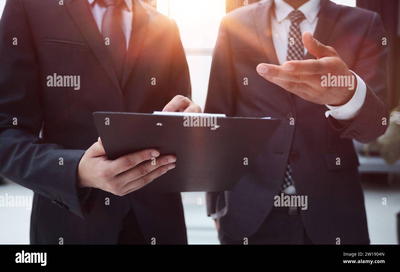 Two Businessmen Having Informal Meeting In Modern Office Stock Photo