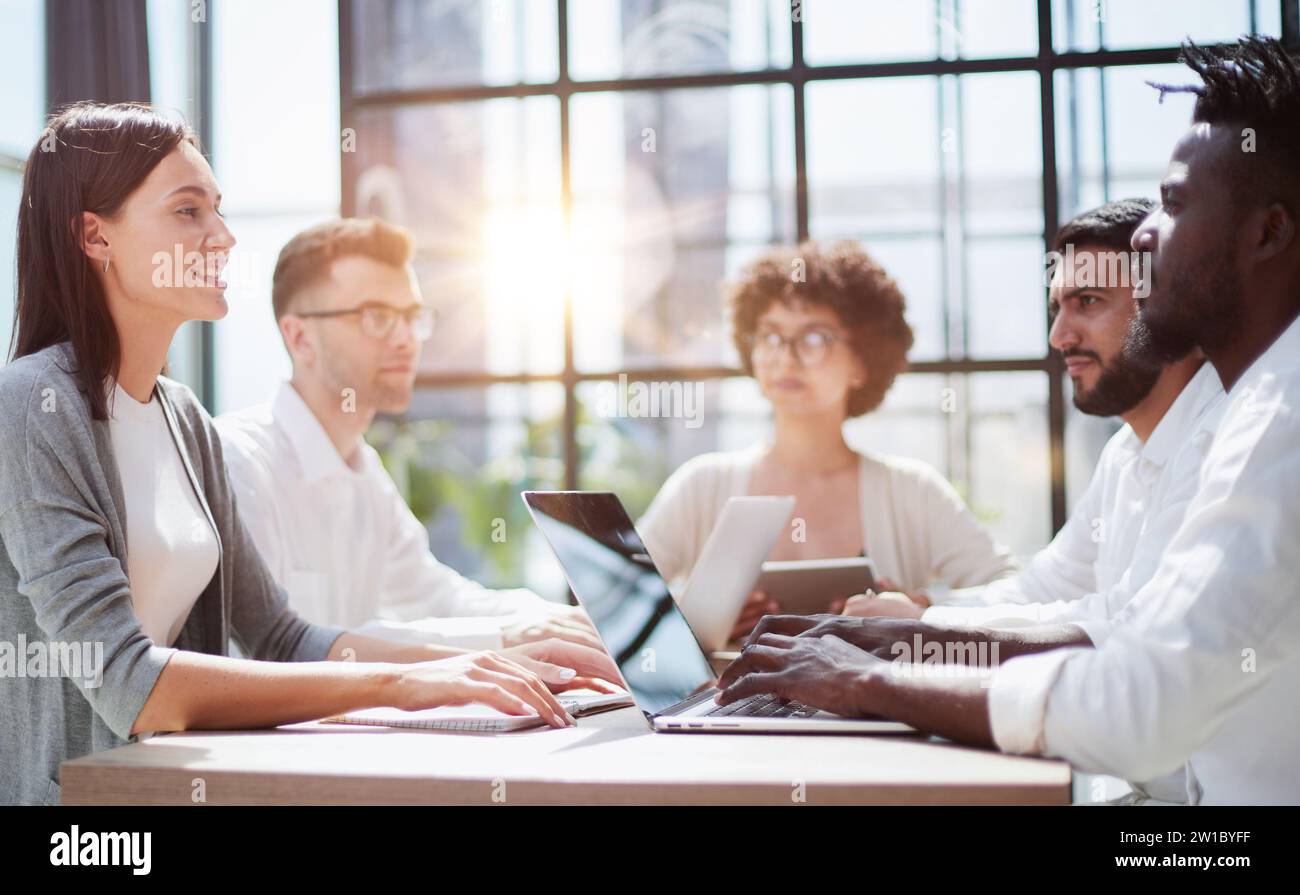 Employees working at computer together, discussing content Stock Photo ...