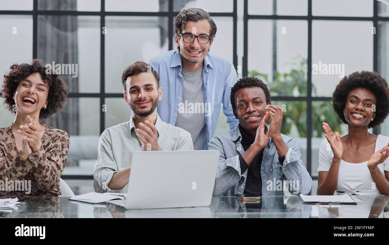 Employees working at computer together, discussing content Stock Photo ...