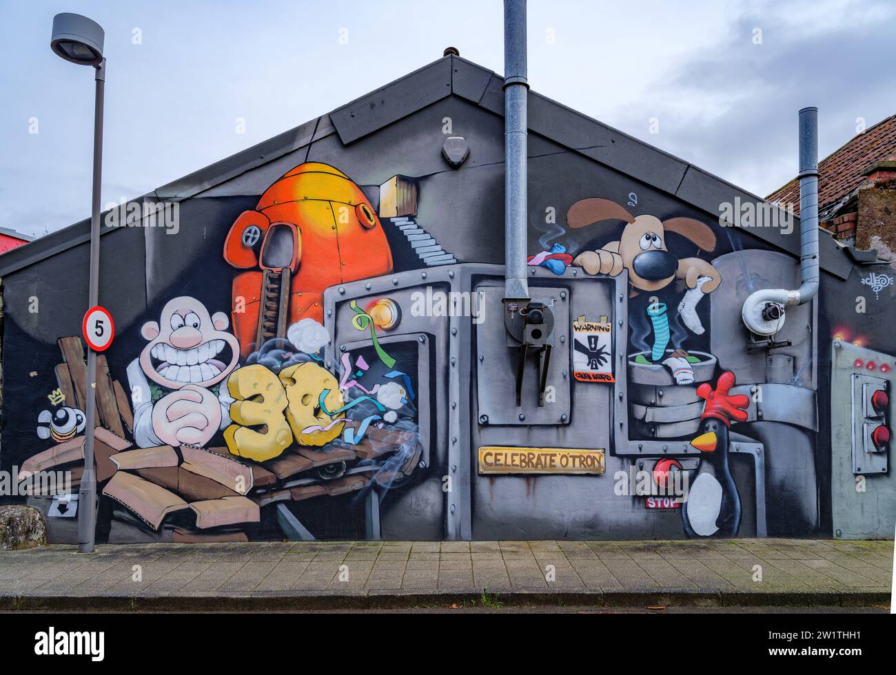 Wallace and Grommit graffiti mural on a Bristol building featuring a Celebratotron machine turning old socks into cheese and ribbons Stock Photo