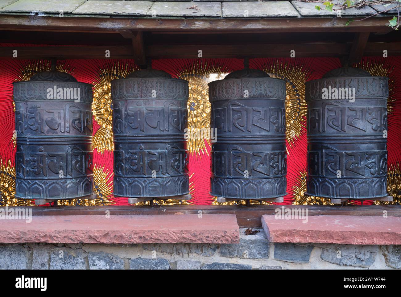 Tibetan prayer wheels by the path up to the Tor in Glastonbury Somerset UK Stock Photo