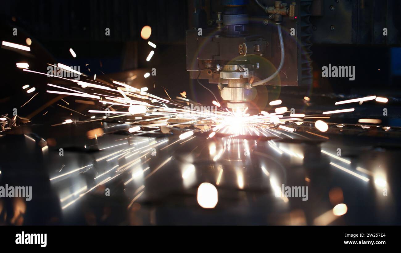 Laser metall cut cnc machine. Fly fire sparks background. Stock Photo