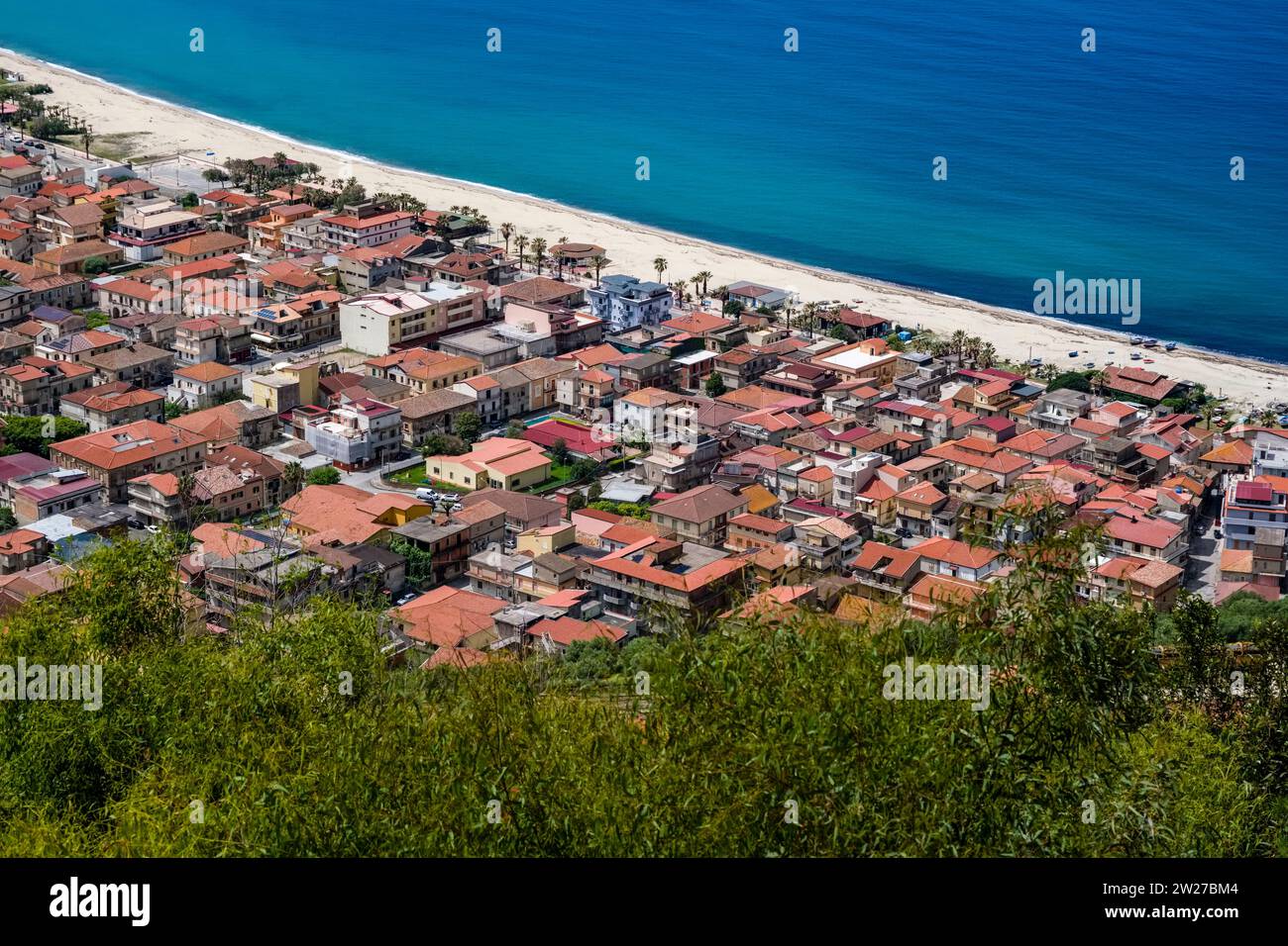 Aerial view of the roofs of the small town of Nicotera Marina, which lies on a white sandy beach. Stock Photo