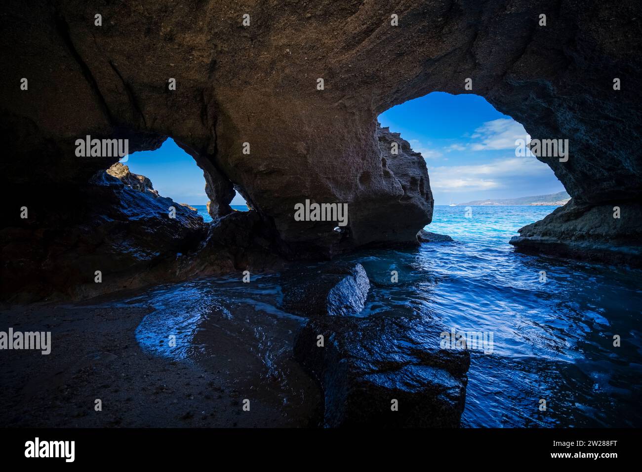 Grotta del Palombaro, a cave below the Santa Maria dell'Isola monastery, which is located on a rock on the coast. Stock Photo