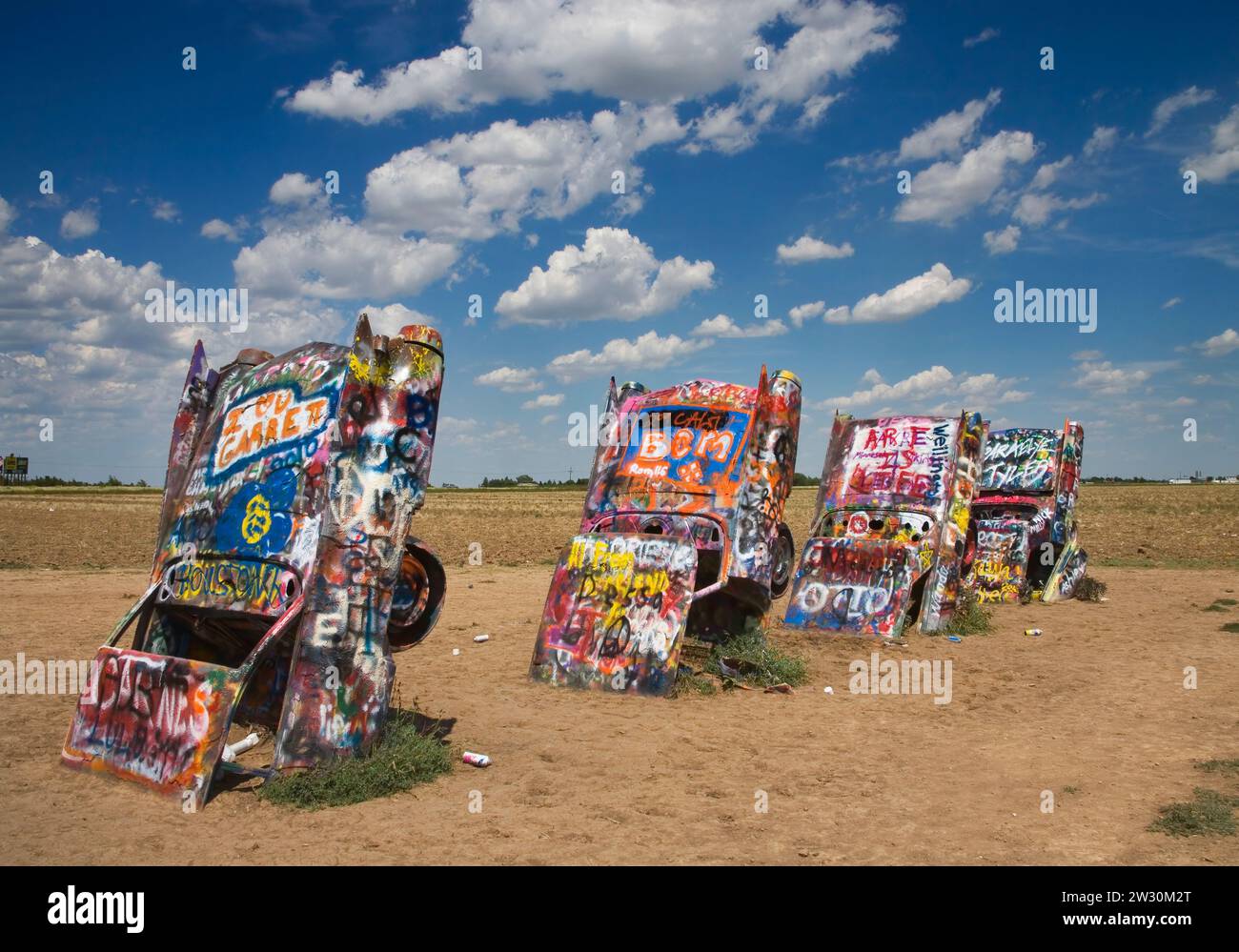the cadillac ranch is a public art installation with graffiti spray