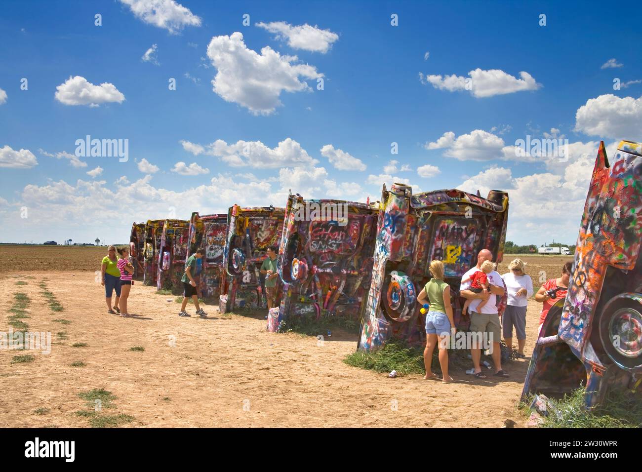 the cadillac ranch is a public art installation with graffiti spray