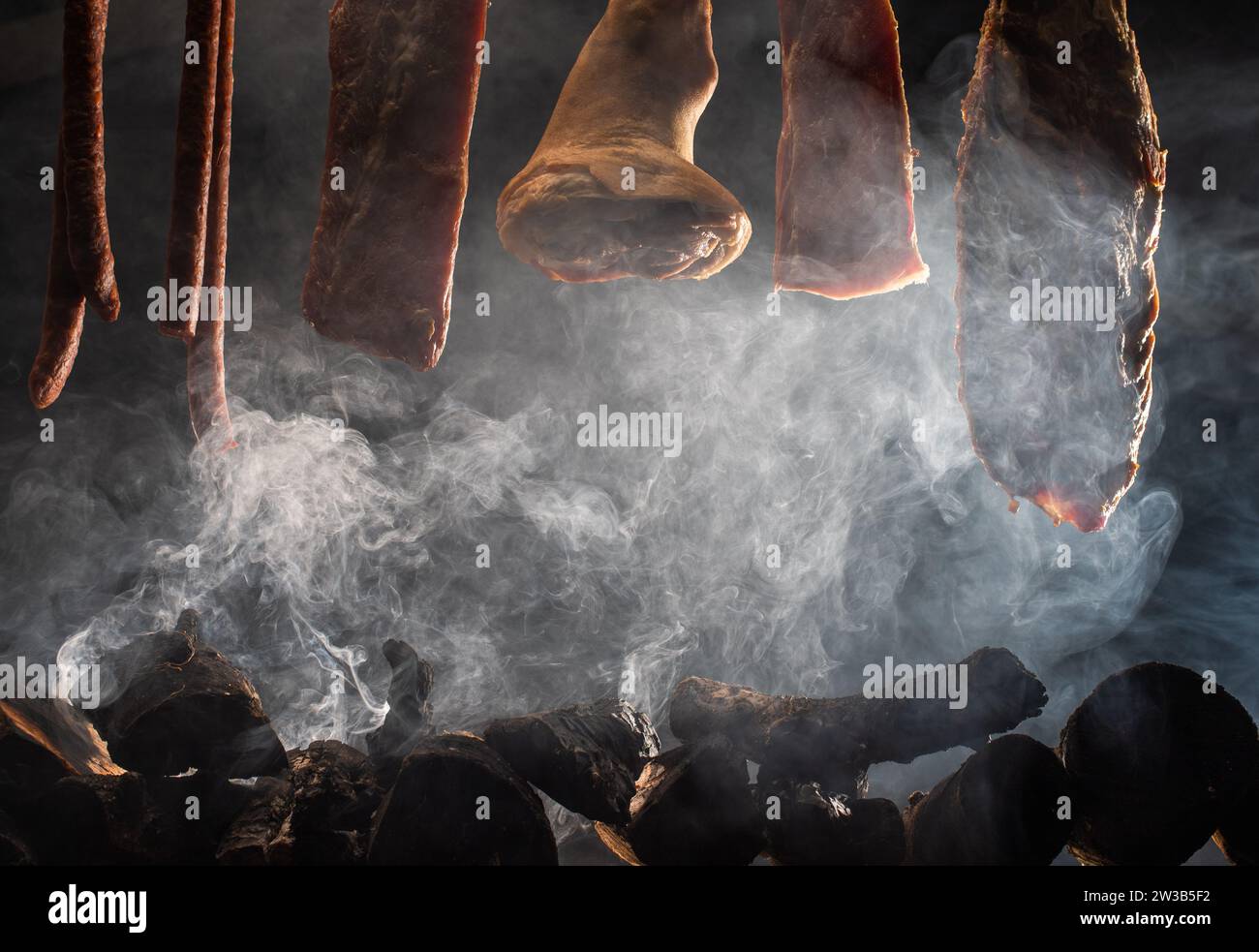 Drying pork meat in smokehouse,ribs,steak, knuckle,  dried sausage, Stock Photo