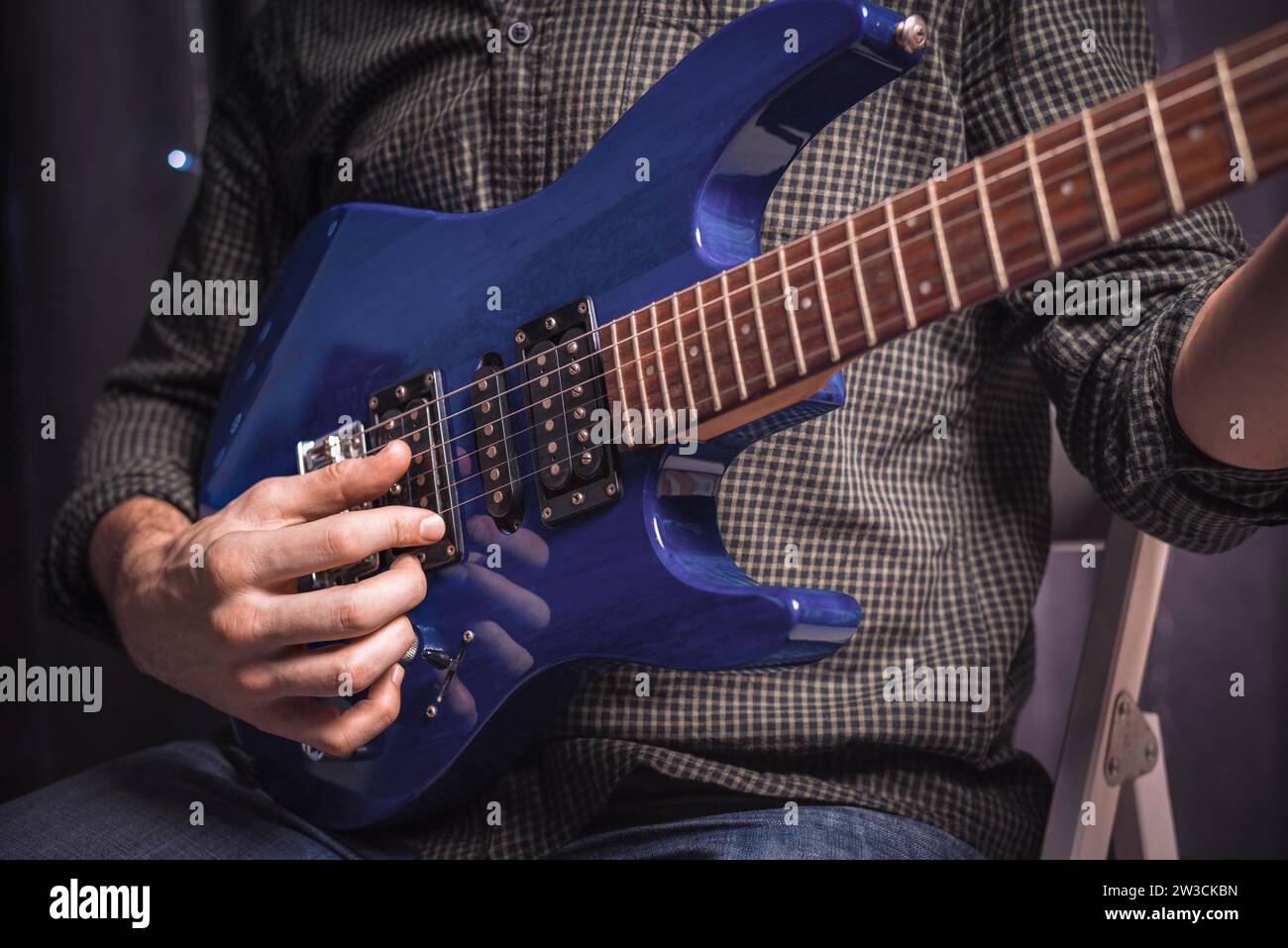 Image of the hands of a musician playing the electric guitar. The concept of concerts and entertainment events. Mixed media Stock Photo