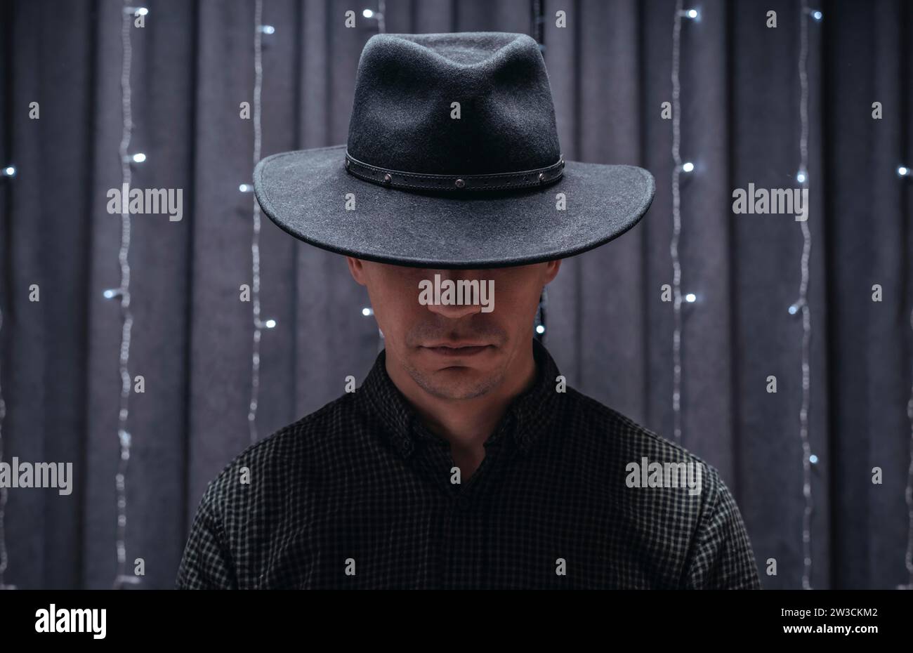 Image of an adult man wearing a black hat. Gangster concept. Mixed media Stock Photo