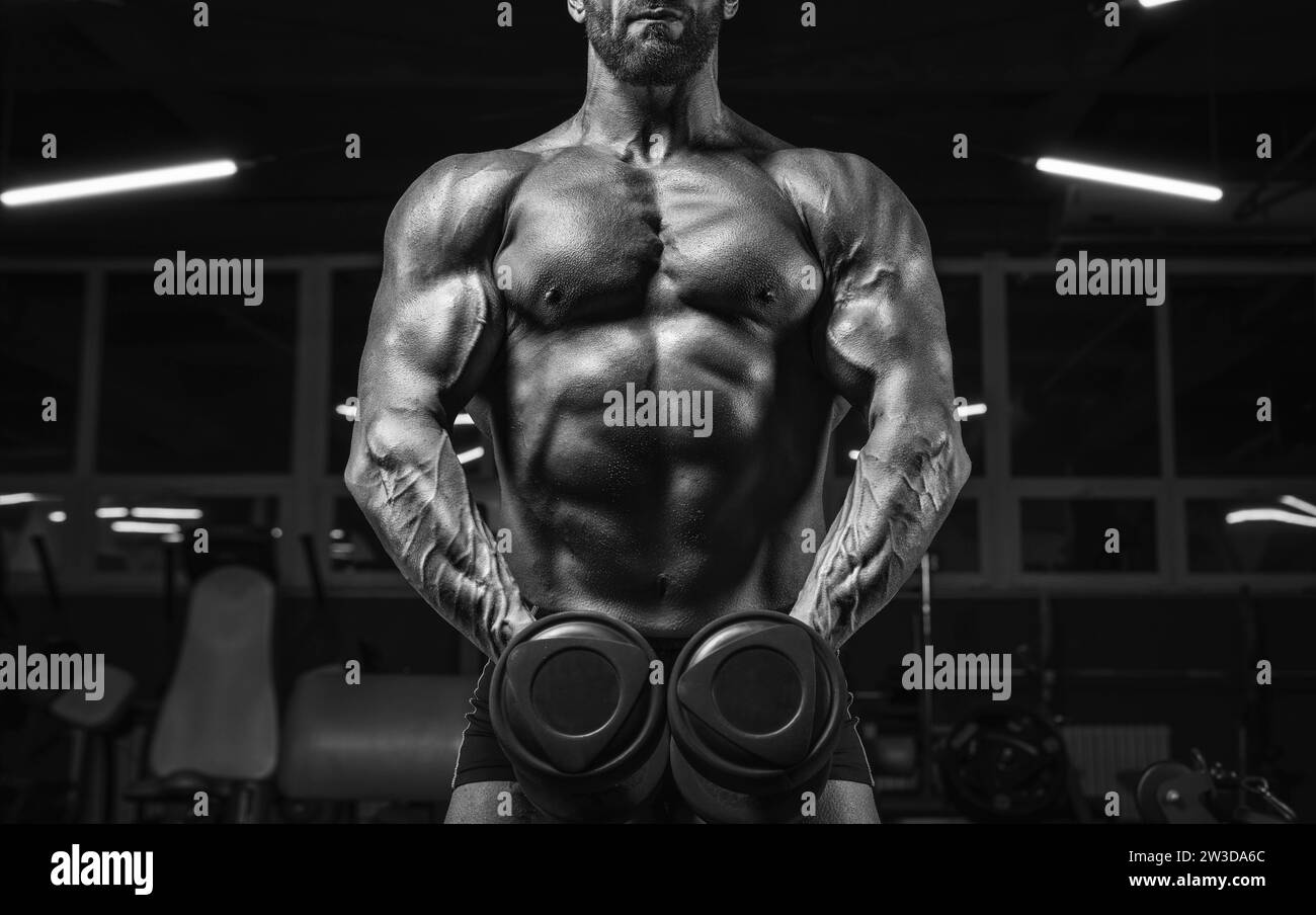 Noname image of a powerful athlete pumping biceps with dumbbells in the