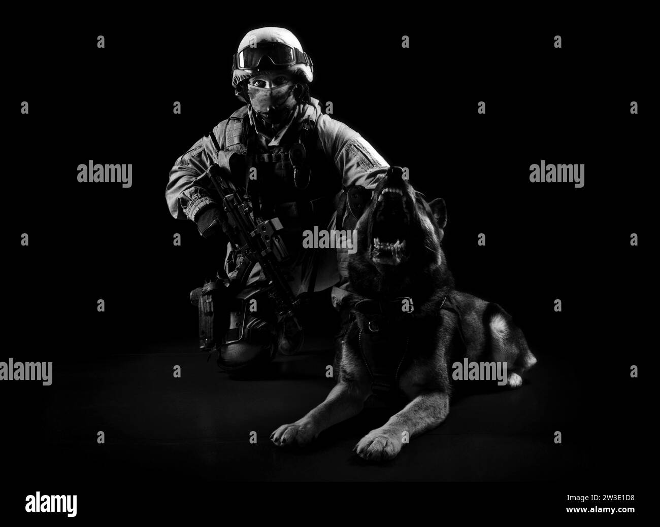 Armed man in military uniform sits next to a search dog. Mixed media Stock Photo