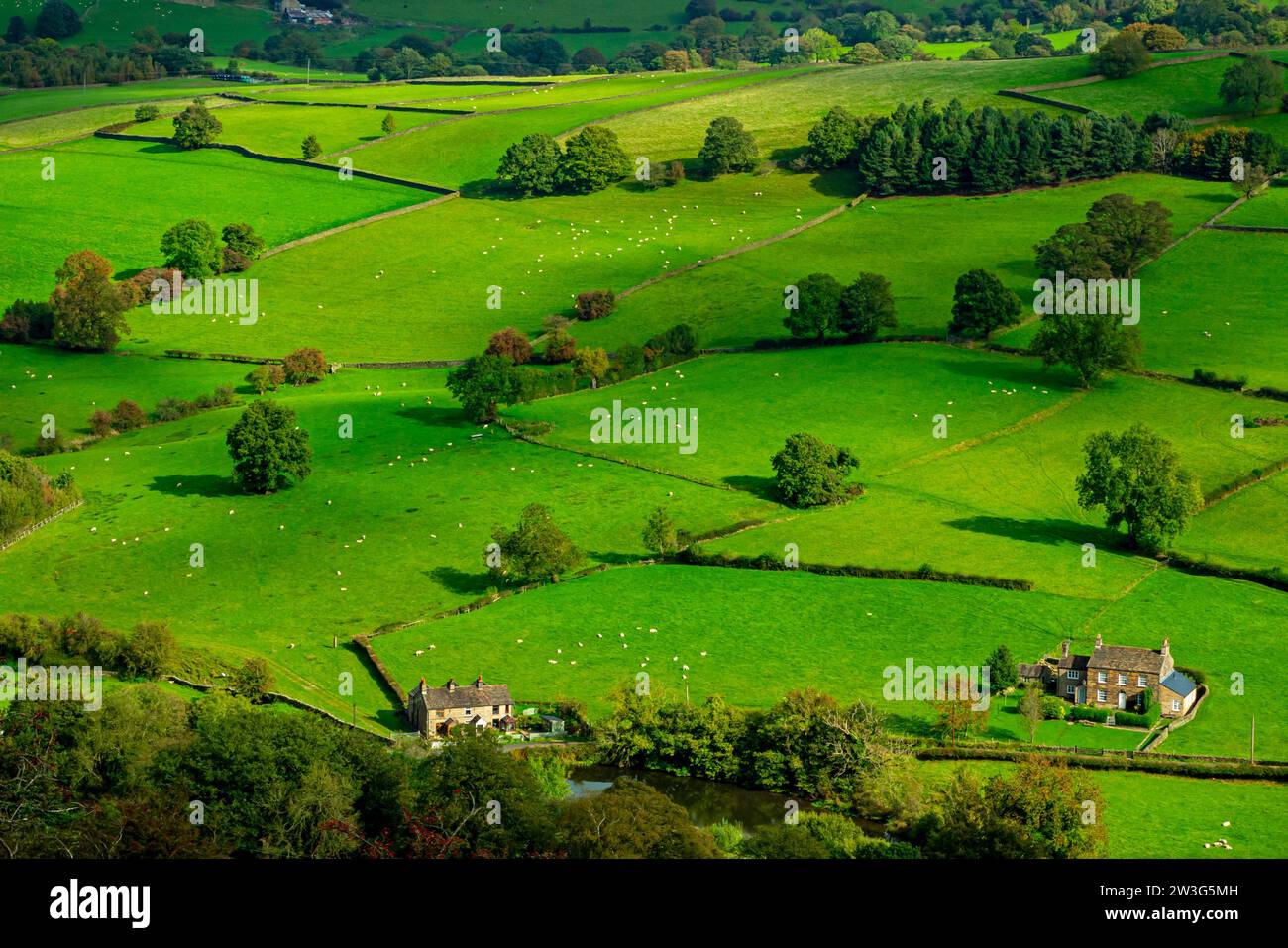 View over fields and farmland near Rainow in Cheshire England UK on the western border of the Peak District with houses at the bottom. Stock Photo