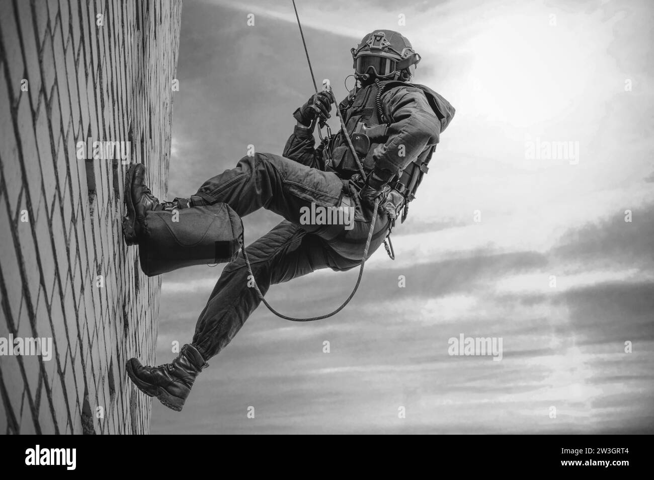 Special forces fighter descends from a skyscraper to storm the apartment. SWAT, police, counter terrorism concept. Mixed media Stock Photo