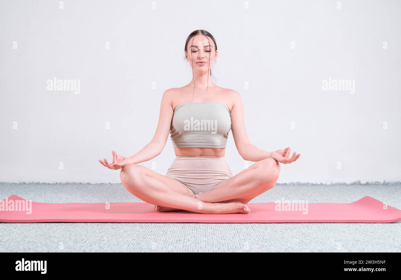 Sporty young woman doing yoga practice. The concept of a healthy
