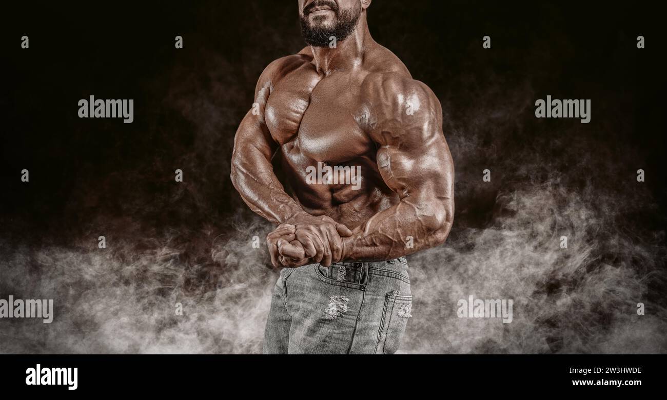 Muscular athlete posing in the studio. Fitness and classic bodybuilding ...