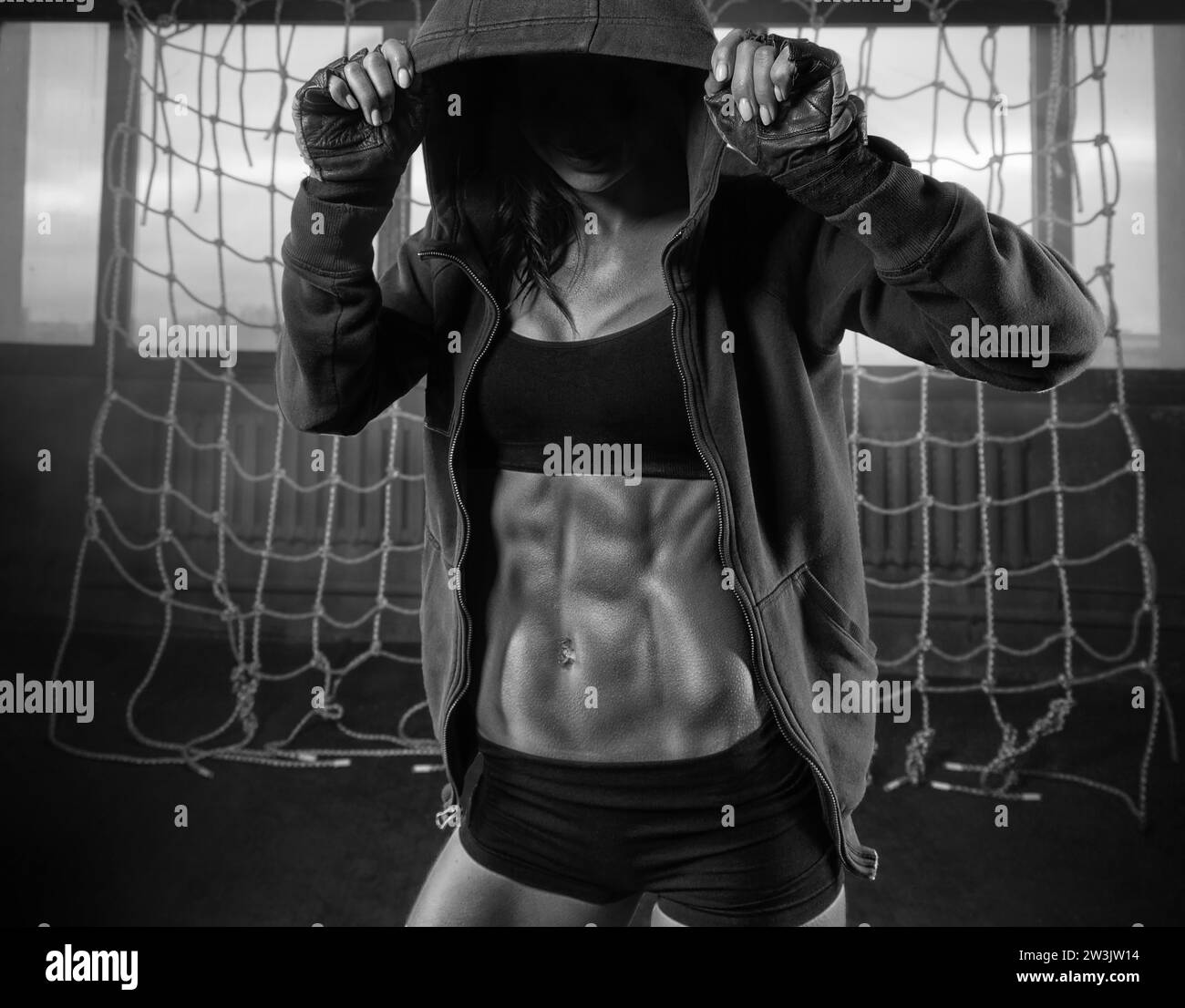No name portrait of a woman with a beautiful abs in a sweatshirt in the