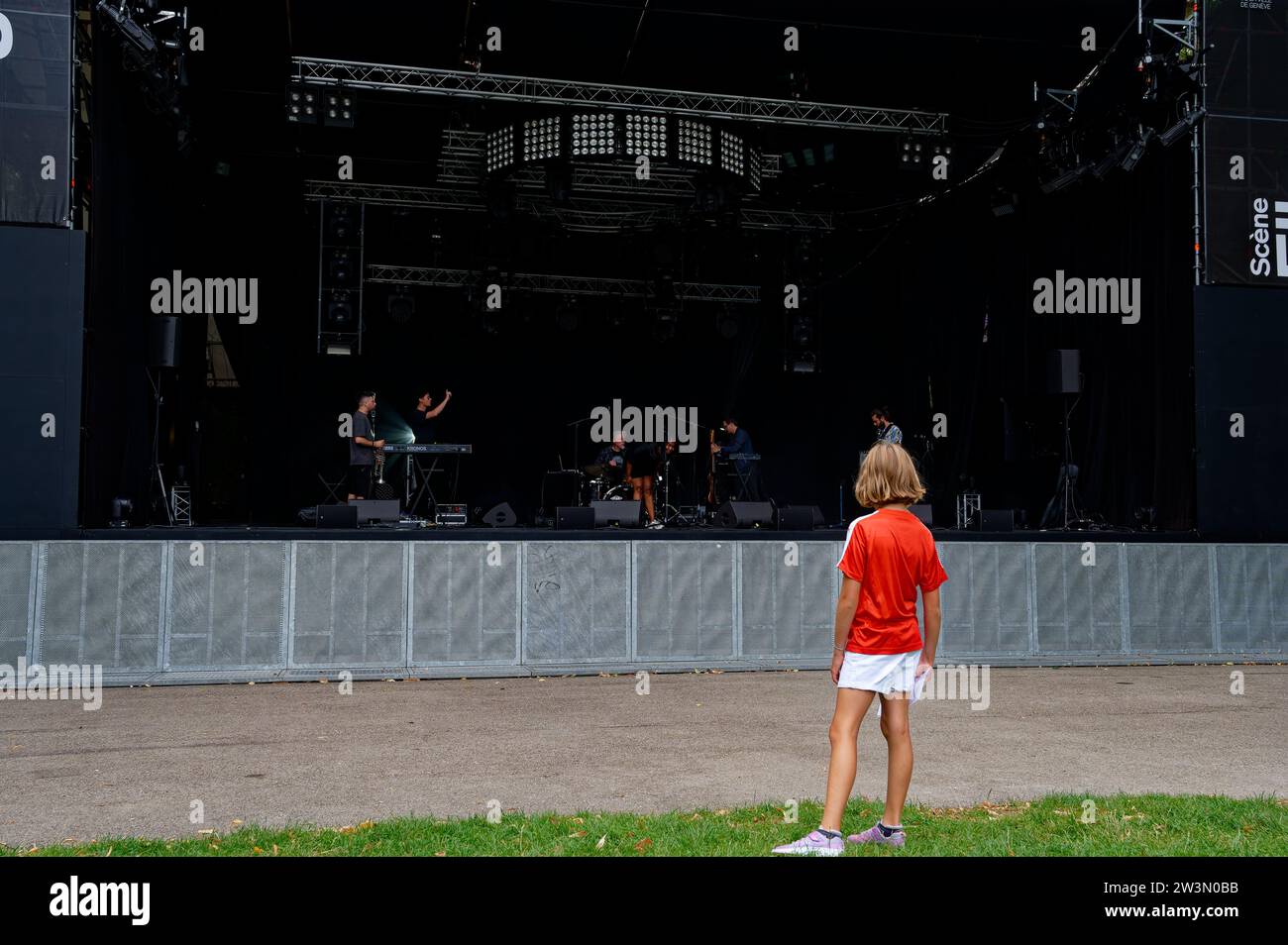 Captivating moment: a blonde, young girl in awe, gazing intently at Evita Koné and her band during their soundcheck, Ella Fitzgerald stage. Stock Photo