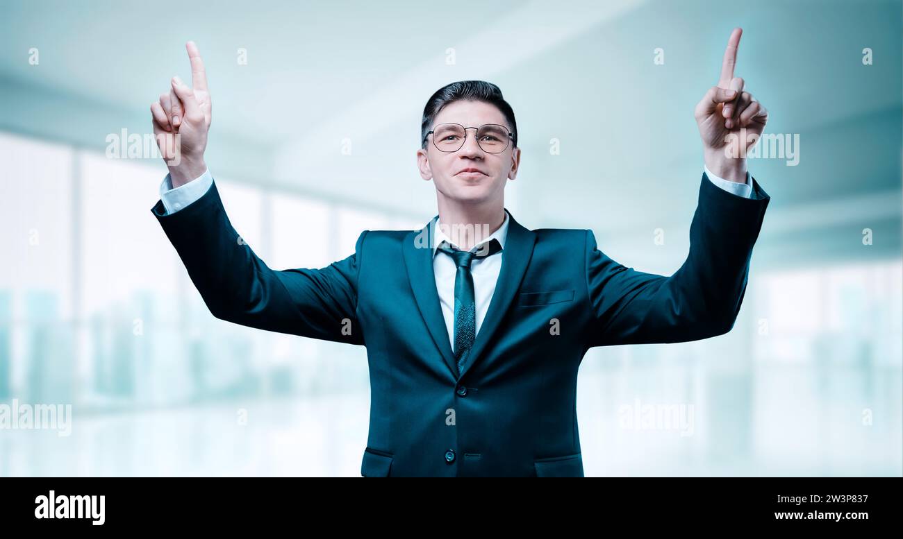 Raised Boss Confident boss in a business suit celebrates victory in the office. His ...