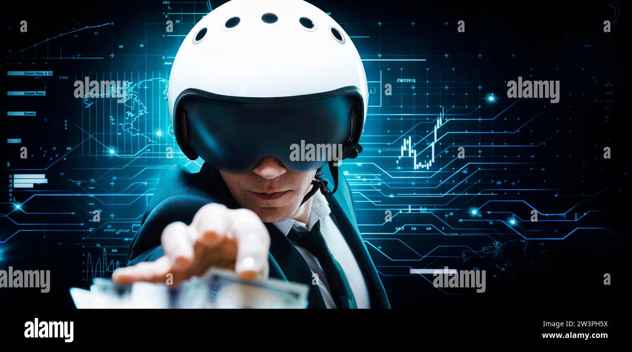 Portrait of a businessman in a suit and aviator helmet. He is trying to reach a pack of hundred-dollar bills. Business concept. Mixed media Stock Photo