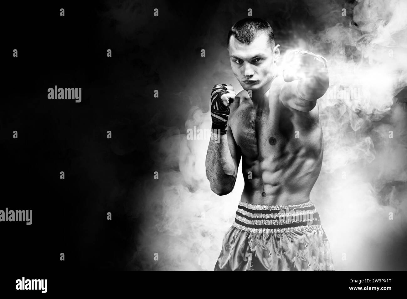 Thai boxer stands in the ring and punches in front of him. The concept