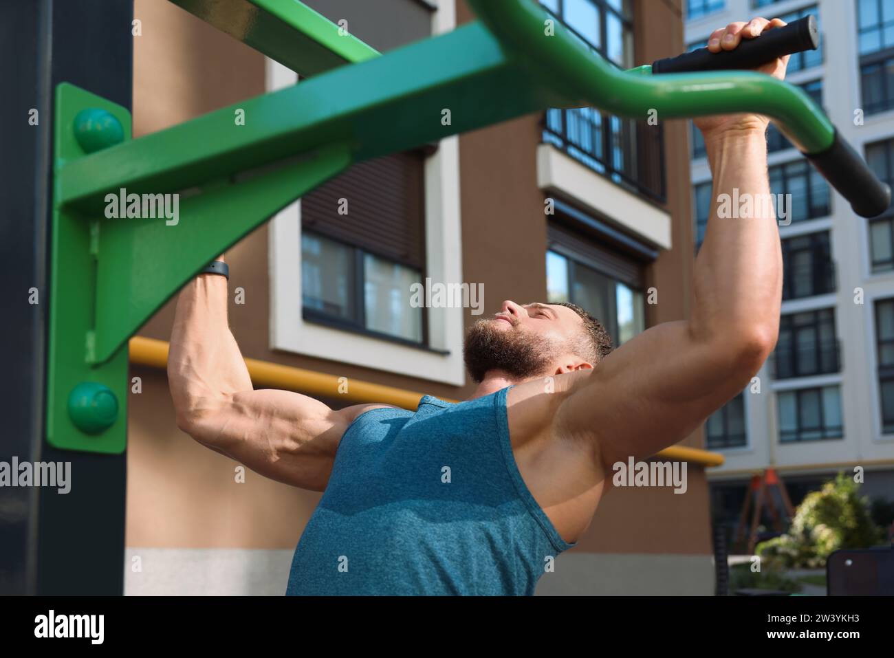 Man doing pull ups at outdoor gym Stock Photo - Alamy