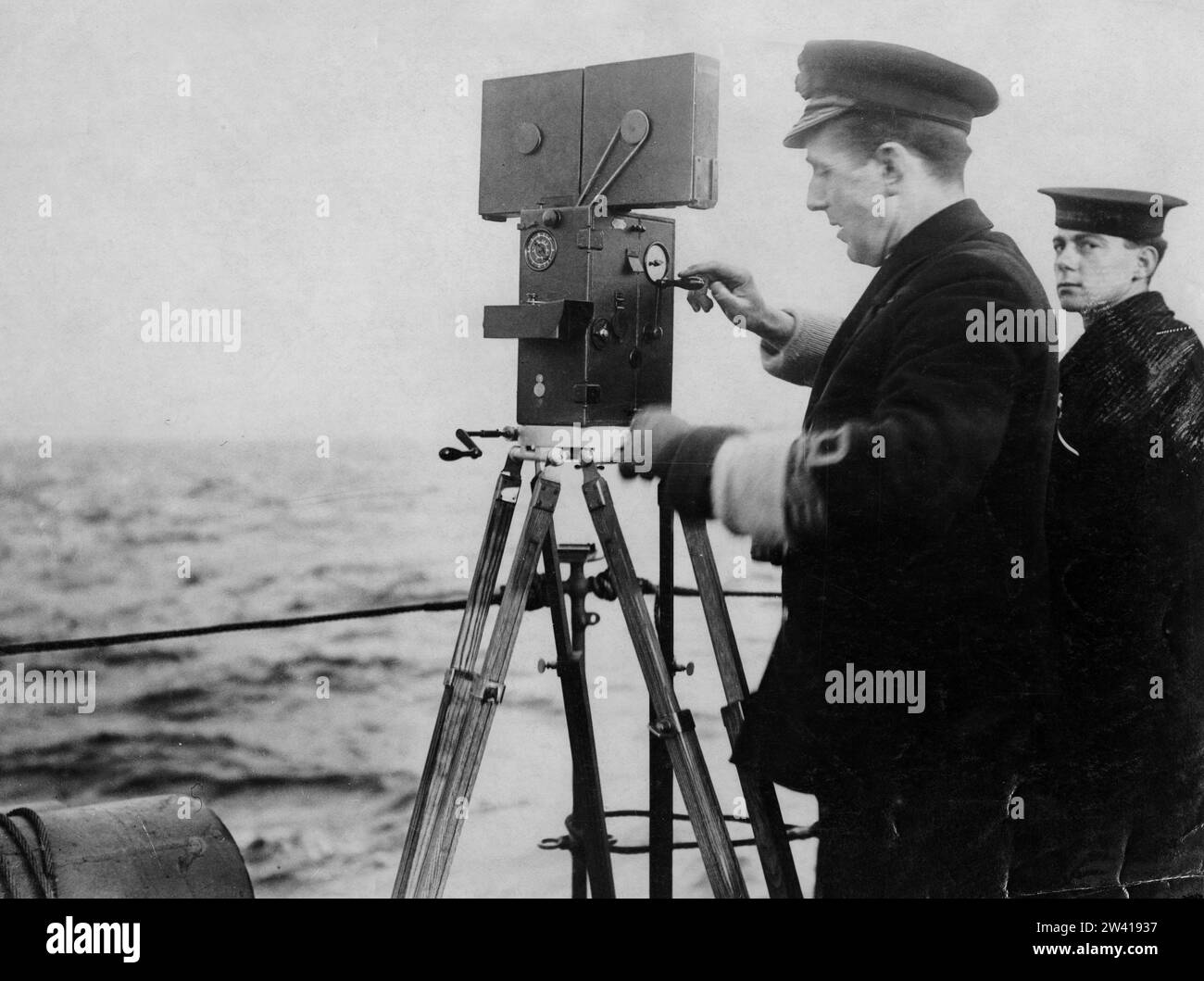 Official photograph showing Navy officer filming aboard a ship Stock Photo