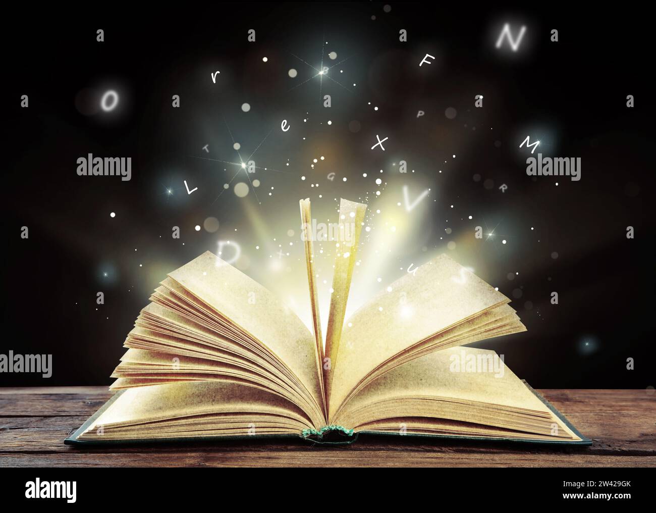 Open book with magic light and glowing letters flying out of it on ...