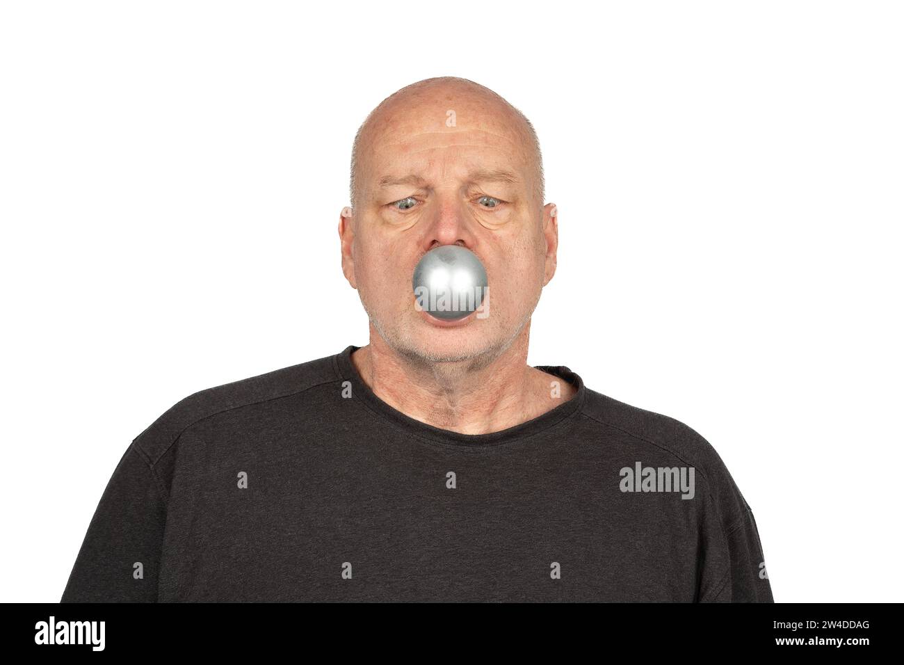 Merry Christmas: Suprised Caucasian Man with Silver Christmas Tree Ornament in Mouth, Copy Space Stock Photo