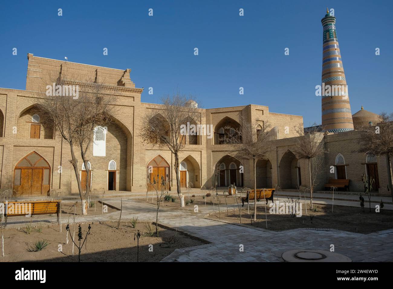 Khiva, Uzbekistan - December 16, 2023: View of the minaret of the Islam Khodja madrasa in the old town of Khiva, Uzbekistan. Stock Photo