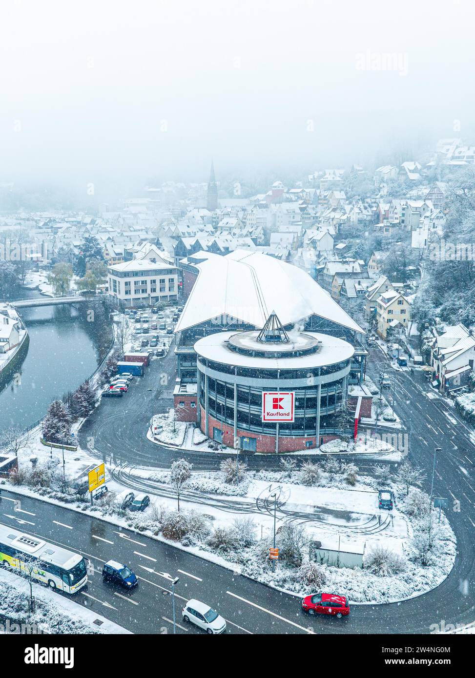 Aerial view of Kaufland, snow-covered shopping centre on a city street from a bird's eye view, Black Forest, Calw, Germany Stock Photo