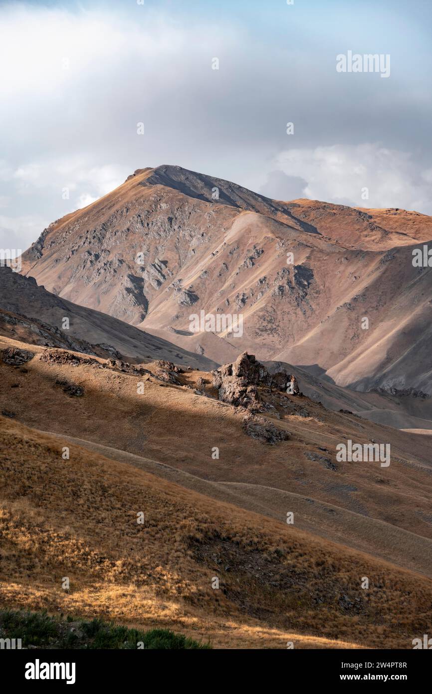 View of mountain landscape with mountain peak at Tyibel Pass, Song Kul Too mountain range, Naryn region, Kyrgyzstan Stock Photo