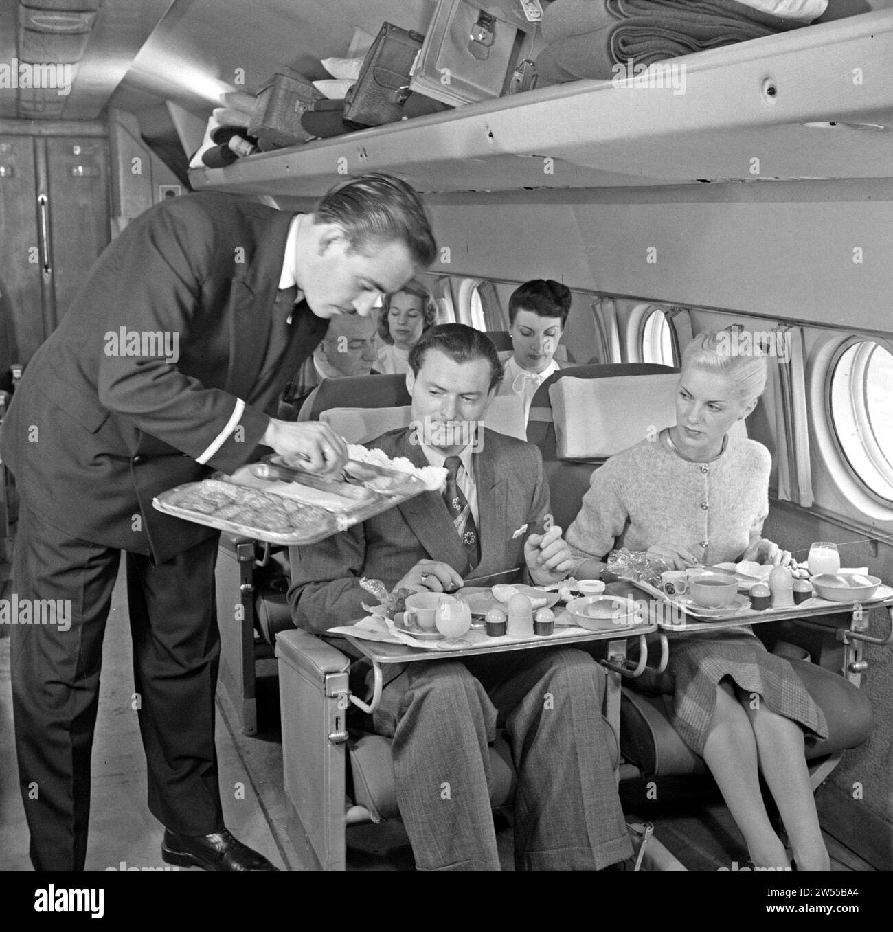 A KLM purser serves the meal during the flight in a KLM passenger plane ca. 1950 Stock Photo