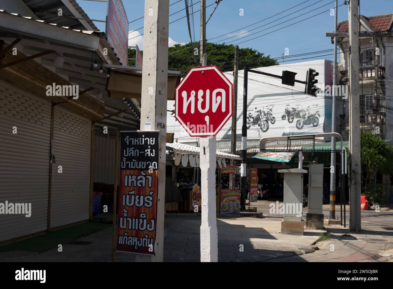 amid-roadside-thai-language-advertising-a-red-and-white-thai-road-sign