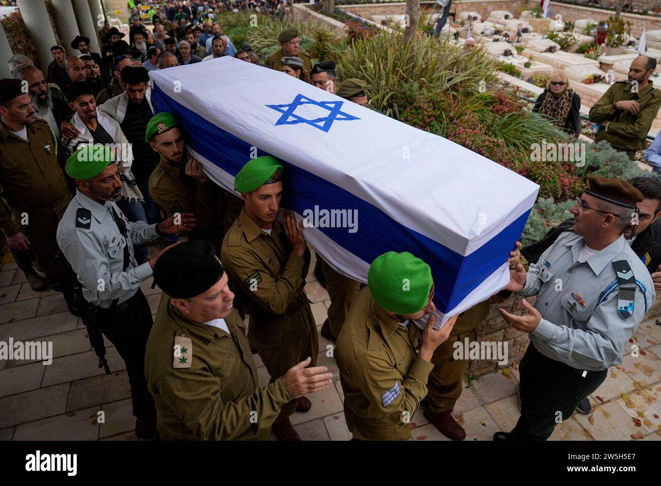 Israeli soldiers carry the flagged covered coffin of Sergeant Lavi