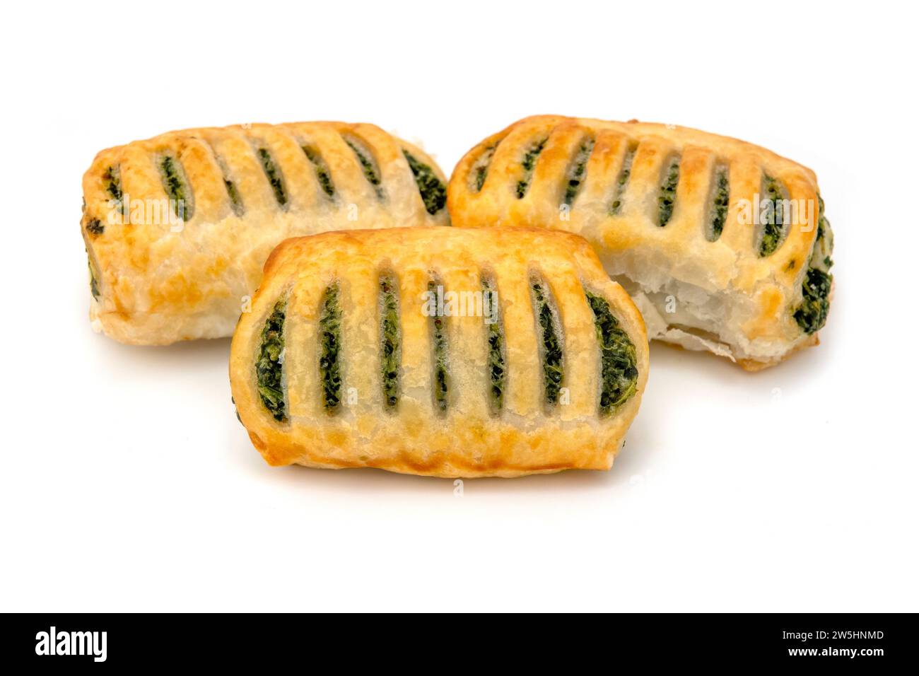 Puff pastry pies filled with spinach on a white background Stock Photo