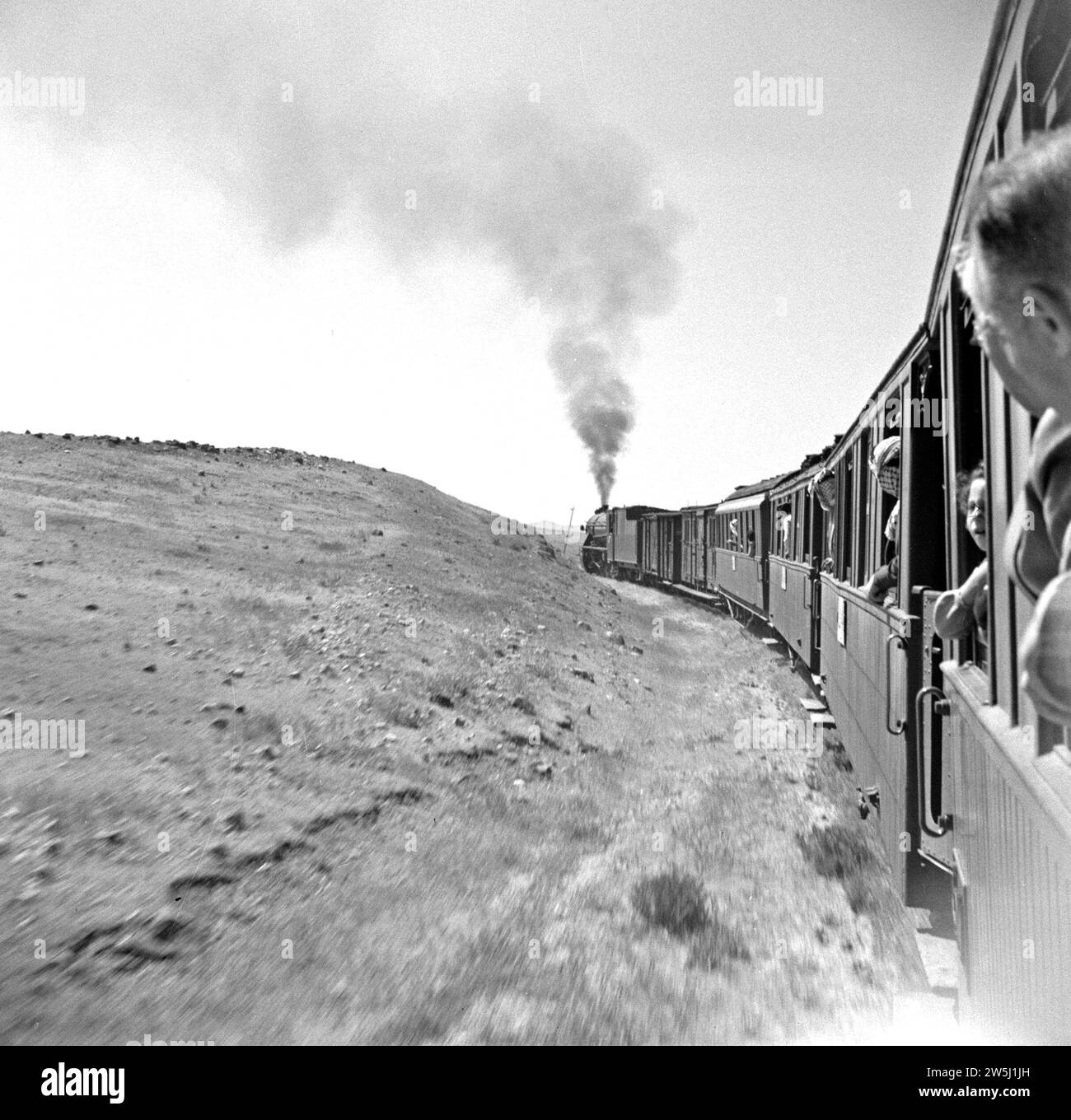 Locomotive and train in motion ca. 1950-1955 Stock Photo