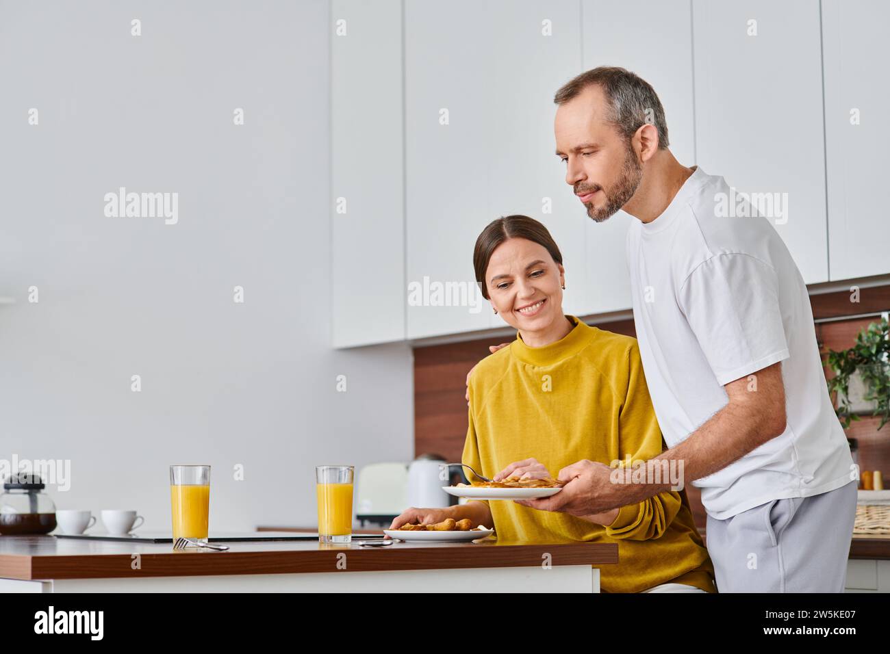 Wife serving food to husband hi-res stock photography and images - Alamy