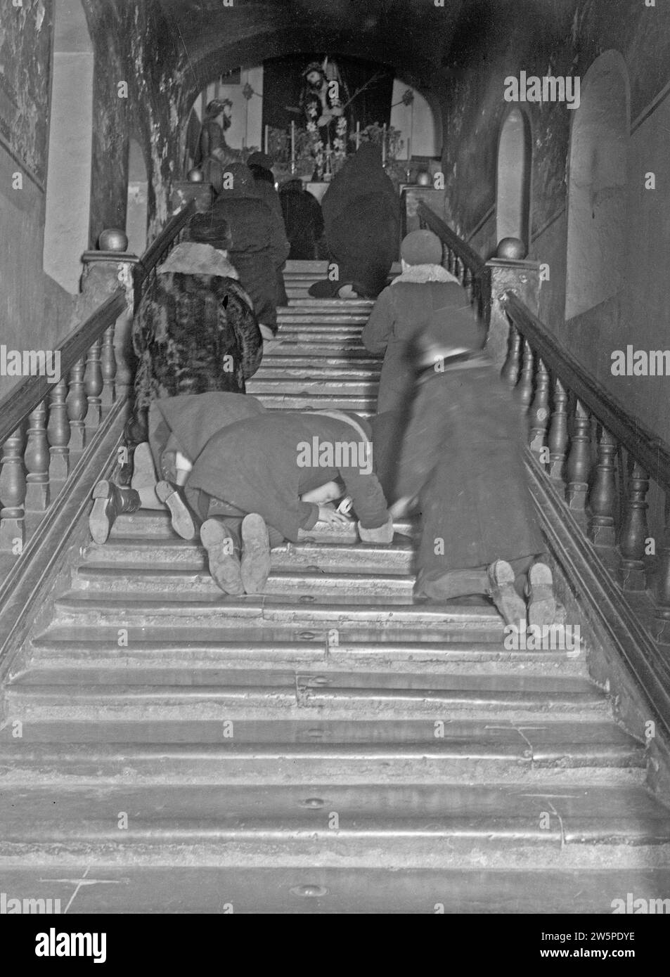 Vilnius. Believers ascend the eighteen steps in St. Anne's Church, in which bone splinters of saints have been incorporated ca. 1934 Stock Photo