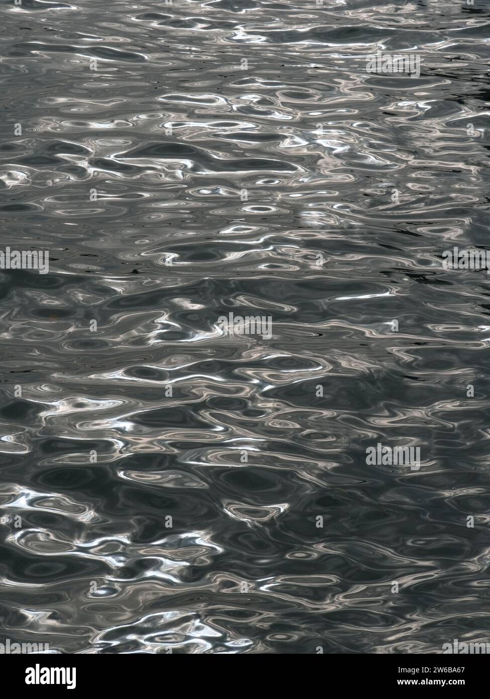 Silvery shimmering water texture in the Venice lagoon. Shimmering water surface Stock Photo