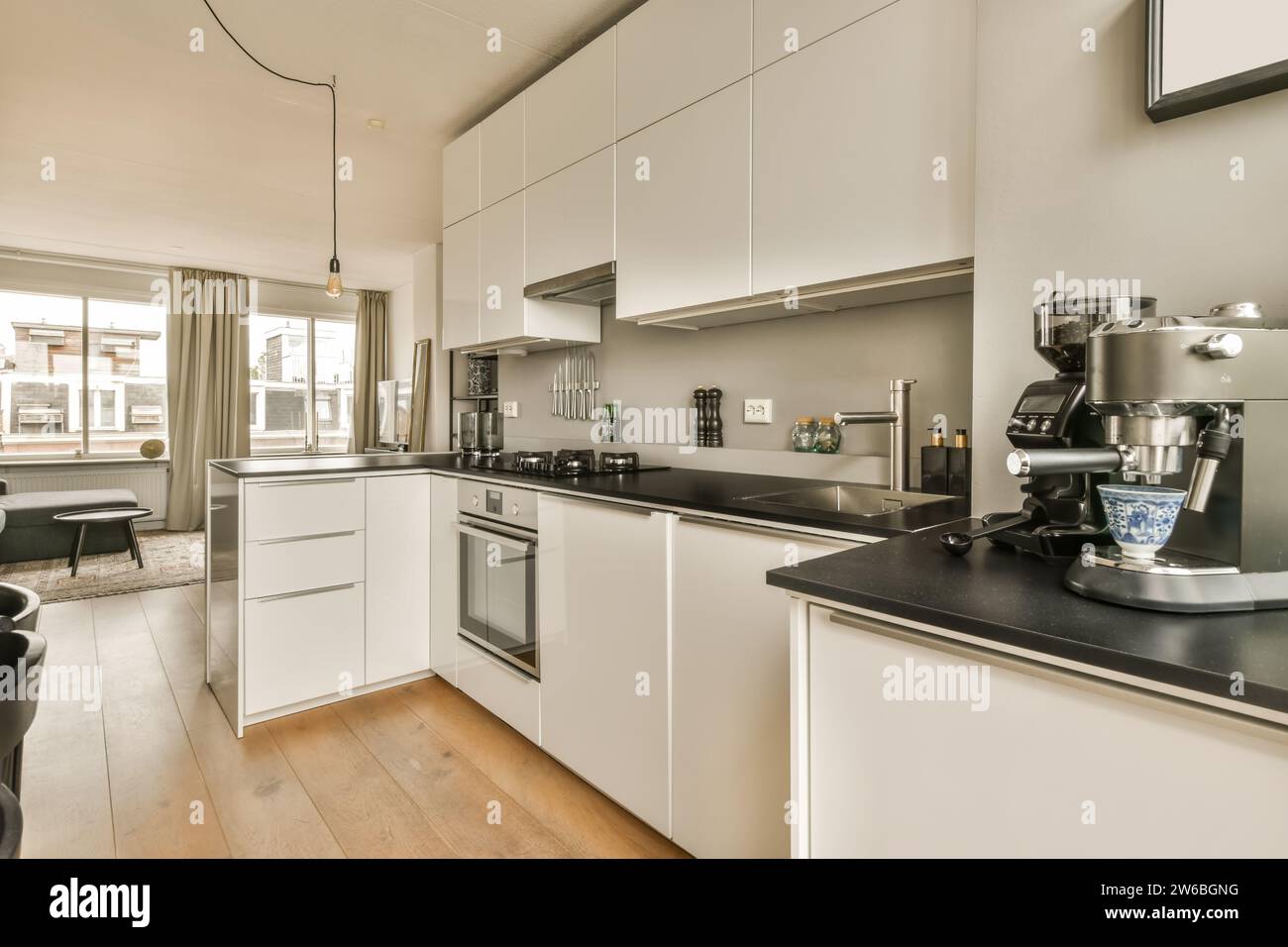 Stove and sink on black countertop in modern kitchen of luxurious ...