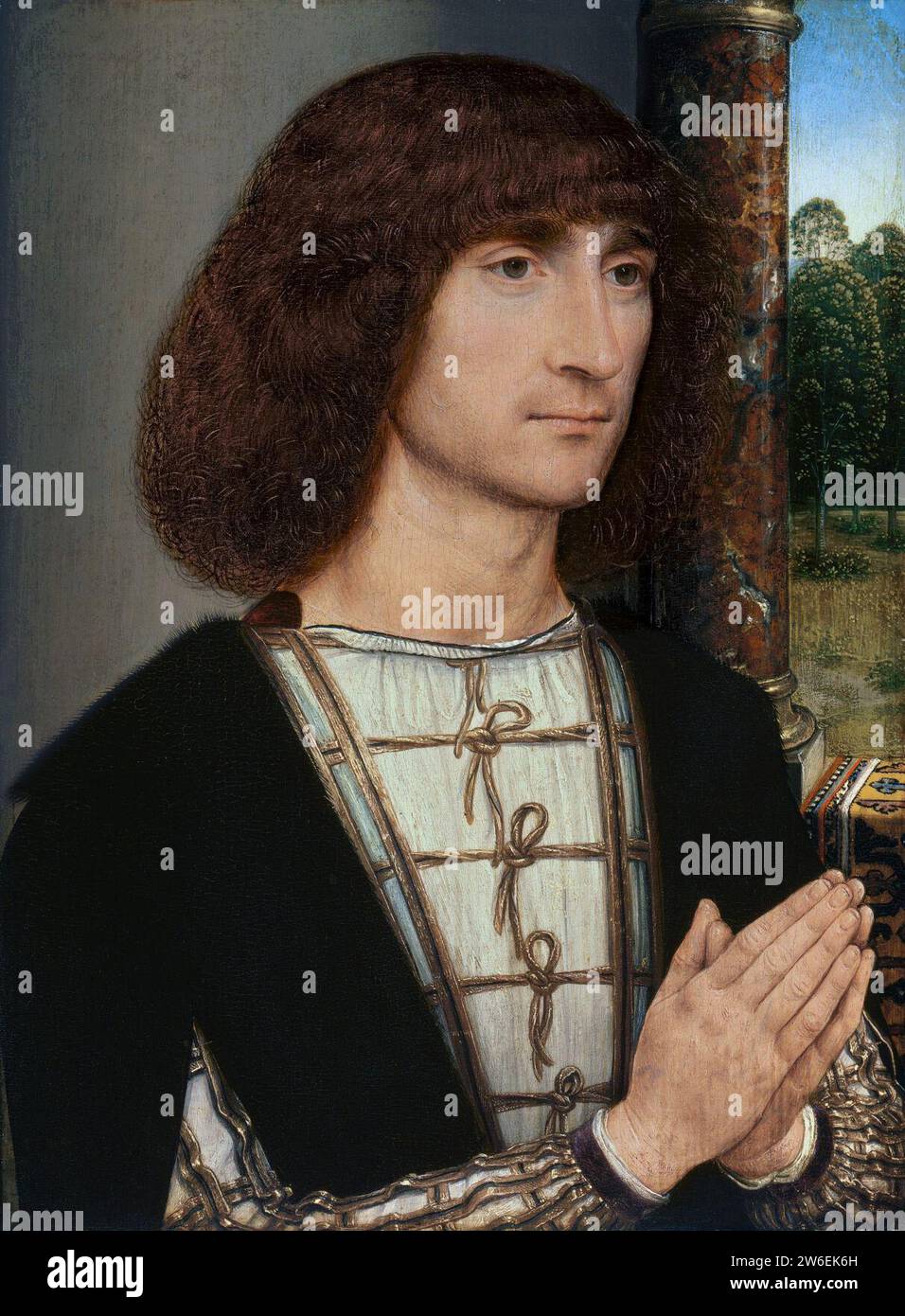 Retrato de un hombre joven orante, por Hans Memling. Stock Photo